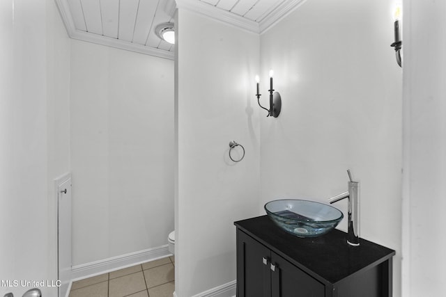 bathroom with vanity, tile patterned flooring, toilet, and crown molding