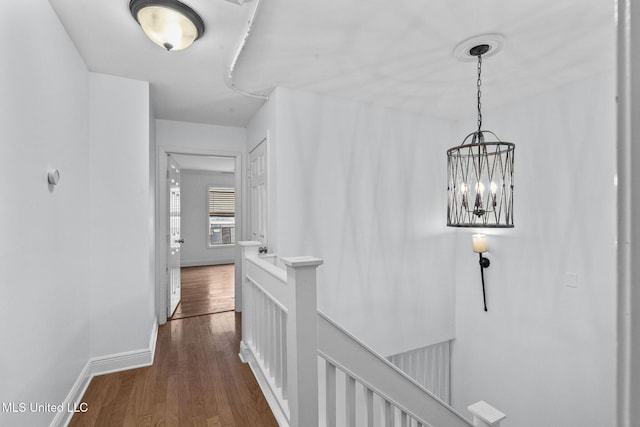 corridor featuring a chandelier and dark hardwood / wood-style floors