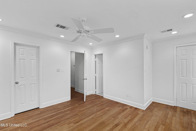 unfurnished bedroom with wood-type flooring, ceiling fan, and crown molding