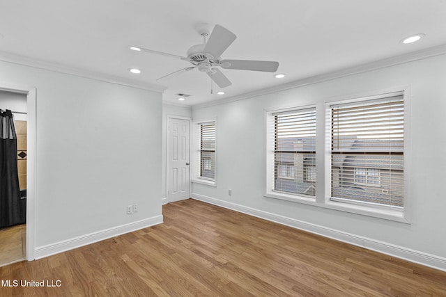 spare room with ceiling fan, crown molding, and light hardwood / wood-style flooring