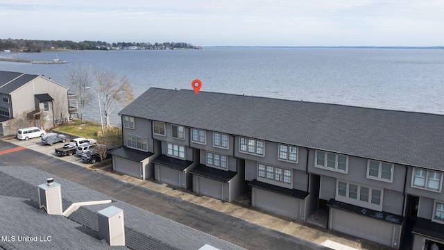 birds eye view of property with a water view