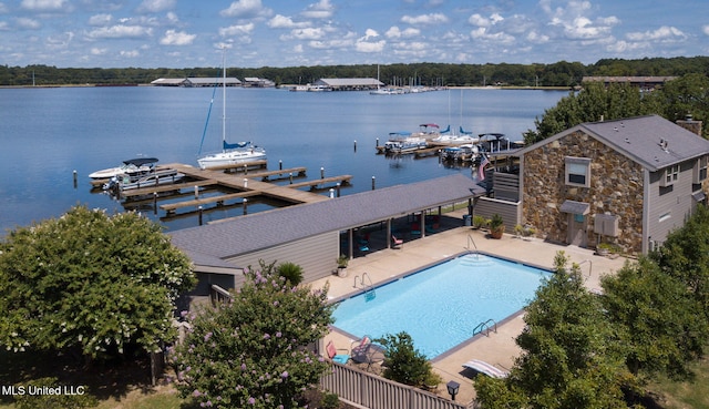 view of swimming pool with a dock, a water view, and a patio area