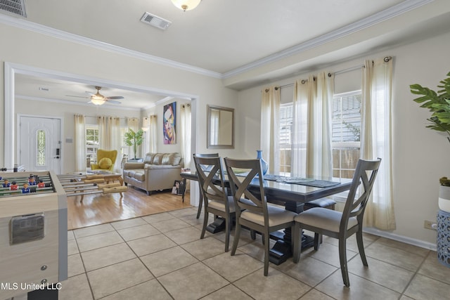 dining space featuring light hardwood / wood-style floors, ceiling fan, and ornamental molding