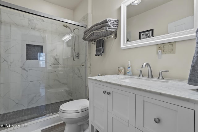 bathroom featuring vanity, hardwood / wood-style flooring, toilet, and walk in shower