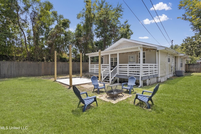 back of house with a yard, central AC, an outdoor fire pit, and a patio area