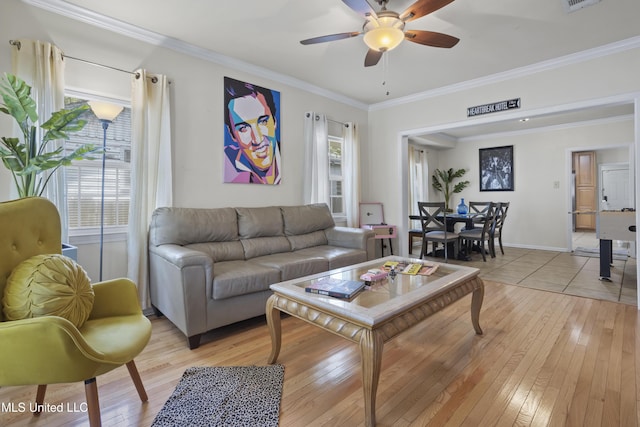 living room featuring light wood-type flooring, ceiling fan, and crown molding