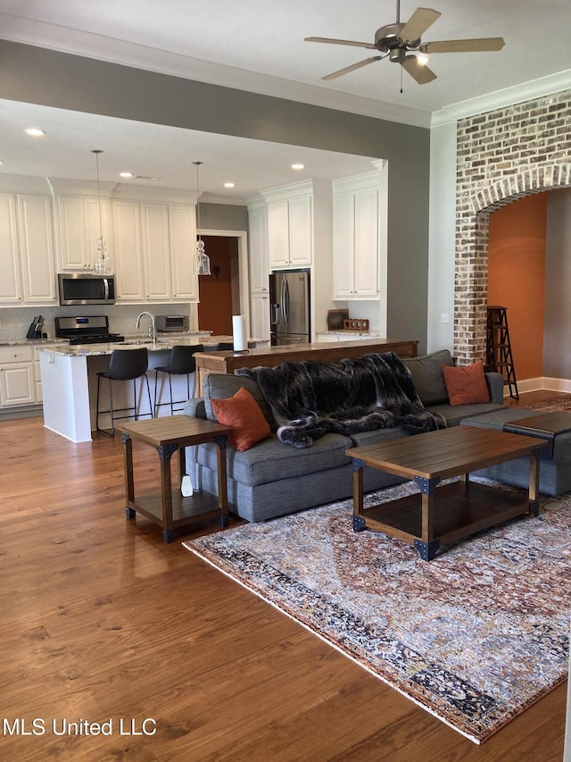 174 Falls Xing, Madison, MS 39110 - living area featuring crown molding, wood finished floors, ceiling fan, and recessed lighting