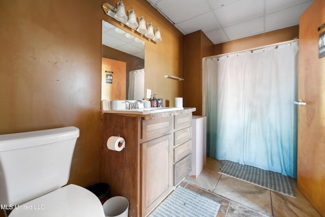 bathroom featuring vanity, a paneled ceiling, and toilet