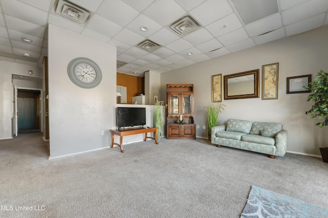 unfurnished living room featuring a paneled ceiling and carpet floors