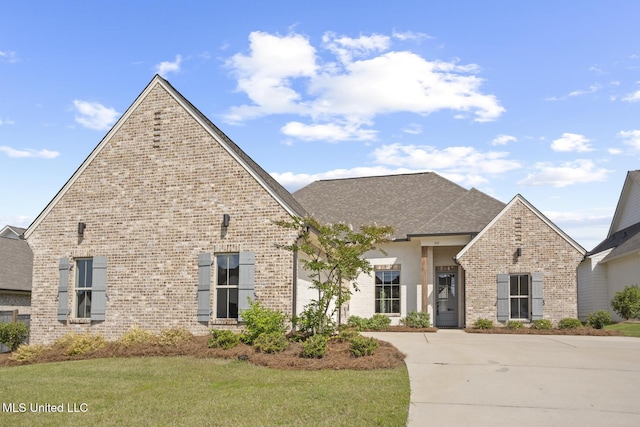 302 Wind Cv, Madison, MS 39110 - french provincial home featuring brick siding, driveway, a front lawn, and a shingled roof