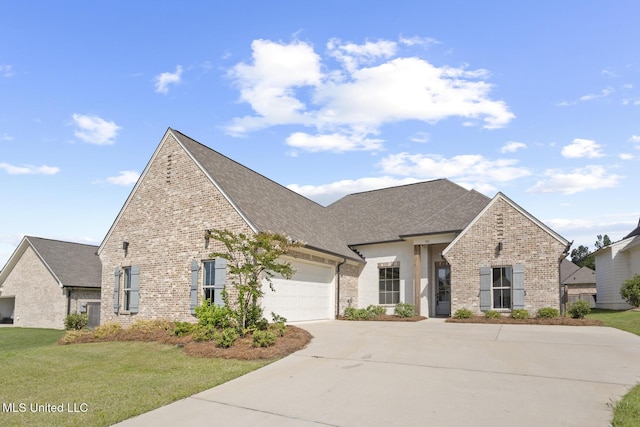 302 Wind Cv, Madison, MS 39110 - french provincial home featuring concrete driveway, a garage, a front lawn, brick siding, and roof with shingles