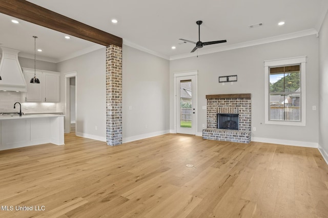 302 Wind Cv, Madison, MS 39110 - unfurnished living room featuring ceiling fan, light wood-type flooring, a fireplace, ornamental molding, and recessed lighting