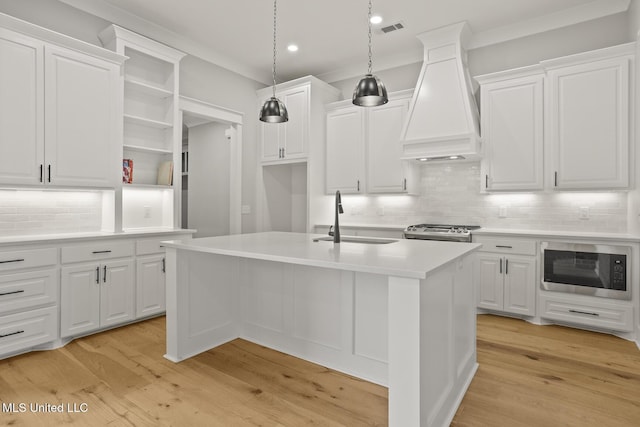 302 Wind Cv, Madison, MS 39110 - kitchen featuring a sink, premium range hood, built in microwave, backsplash, and light countertops