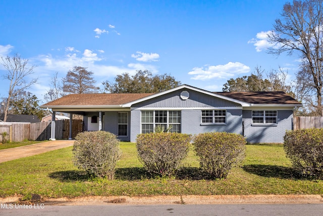 ranch-style house with brick siding, concrete driveway, a front yard, fence, and a carport