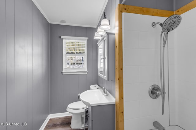 full bathroom featuring a shower, crown molding, toilet, vanity, and wood finished floors