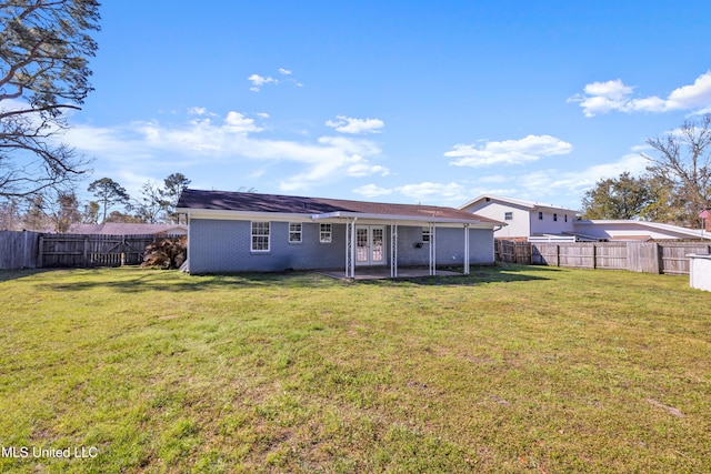 back of property with a patio, brick siding, a lawn, and a fenced backyard