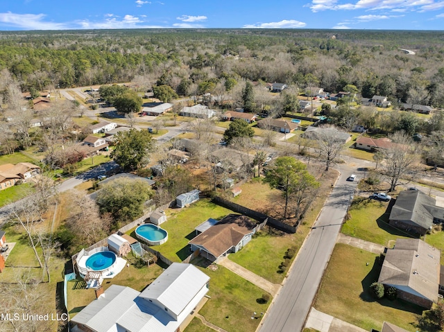 bird's eye view with a wooded view