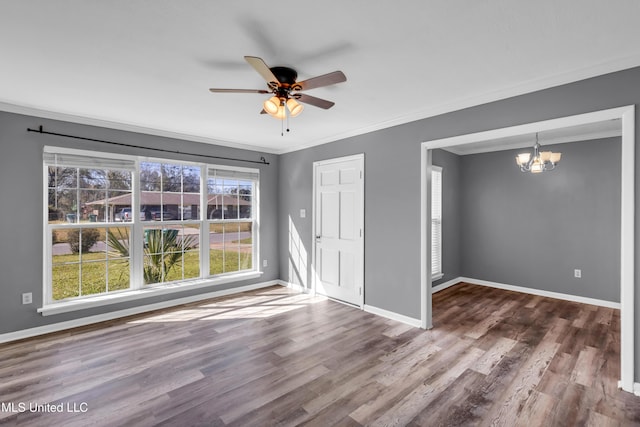 unfurnished room with ceiling fan with notable chandelier, crown molding, baseboards, and wood finished floors