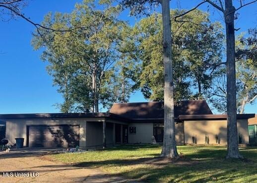 view of front of property with a garage and a front lawn