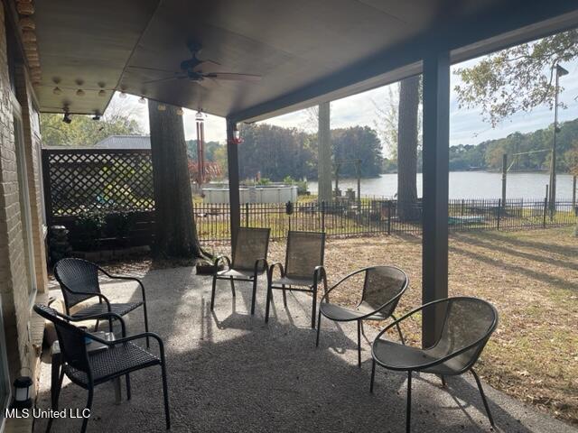 view of patio / terrace with ceiling fan and a water view