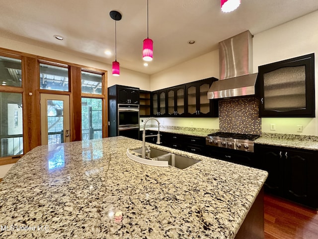 211 Monterey Dr, Clinton, MS 39056 - kitchen with a sink, wall chimney range hood, stainless steel appliances, glass insert cabinets, and a large island