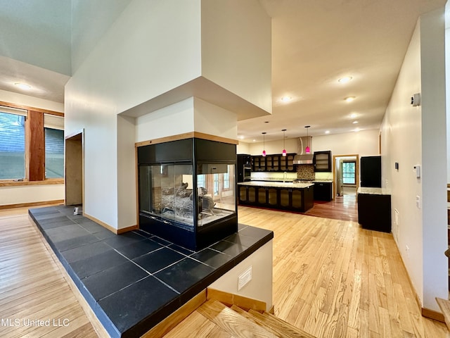211 Monterey Dr, Clinton, MS 39056 - kitchen with light wood finished floors, a center island, light countertops, plenty of natural light, and recessed lighting