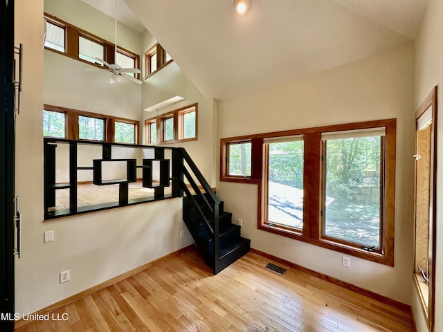 211 Monterey Dr, Clinton, MS 39056 - staircase with healthy amount of natural light, hardwood / wood-style floors, baseboards, and a high ceiling
