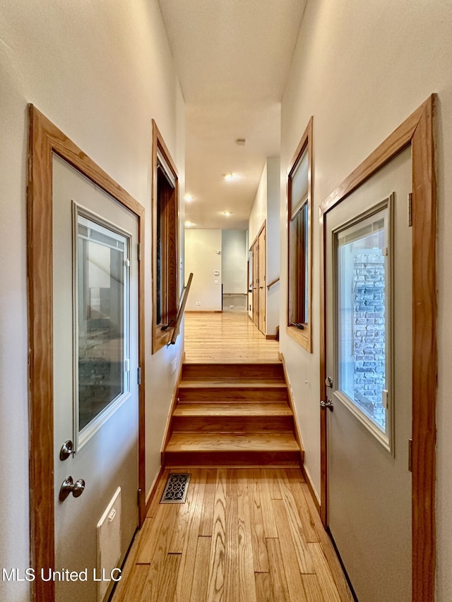 211 Monterey Dr, Clinton, MS 39056 - hallway with light wood-style flooring, stairs, and baseboards