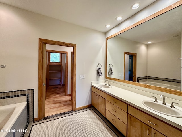 211 Monterey Dr, Clinton, MS 39056 - bathroom featuring double vanity, a bath, recessed lighting, baseboards, and tile patterned floors