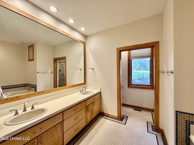 211 Monterey Dr, Clinton, MS 39056 - full bathroom with double vanity, a garden tub, tile patterned floors, baseboards, and recessed lighting