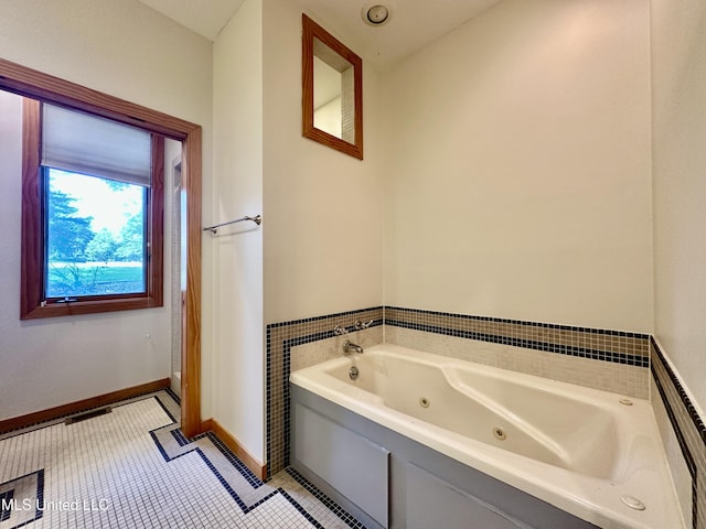 211 Monterey Dr, Clinton, MS 39056 - bathroom featuring a tub with jets, baseboards, and tile patterned floors