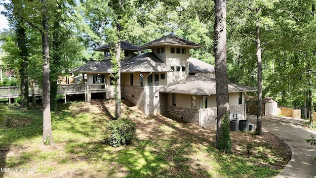 211 Monterey Dr, Clinton, MS 39056 - rear view of house with an outbuilding, a wooden deck, and brick siding