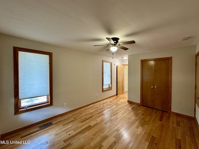 211 Monterey Dr, Clinton, MS 39056 - unfurnished bedroom featuring baseboards, light wood-style floors, and ceiling fan