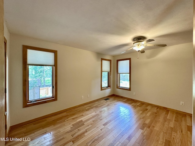 211 Monterey Dr, Clinton, MS 39056 - empty room featuring light wood-style flooring, a ceiling fan, and baseboards
