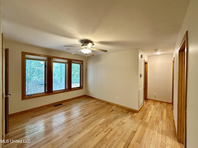211 Monterey Dr, Clinton, MS 39056 - empty room with light wood-type flooring, a ceiling fan, and baseboards