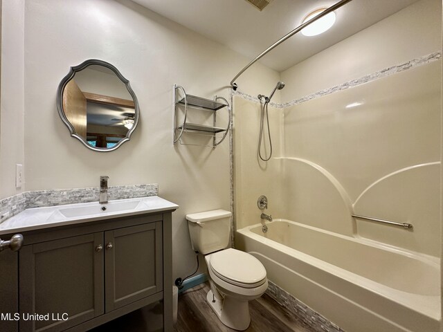 211 Monterey Dr, Clinton, MS 39056 - full bathroom with wood finished floors, toilet, vanity, and shower / bathtub combination