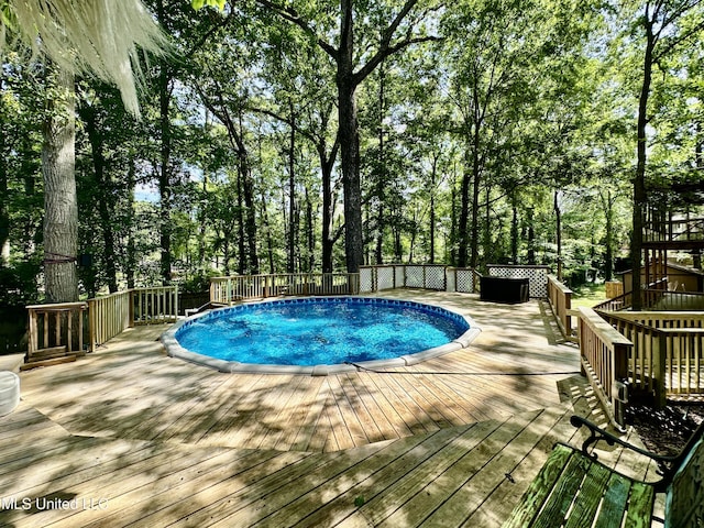 211 Monterey Dr, Clinton, MS 39056 - view of pool with a wooden deck and view of scattered trees