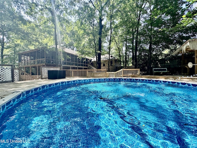 211 Monterey Dr, Clinton, MS 39056 - swimming pool featuring a deck, stairs, and a sunroom