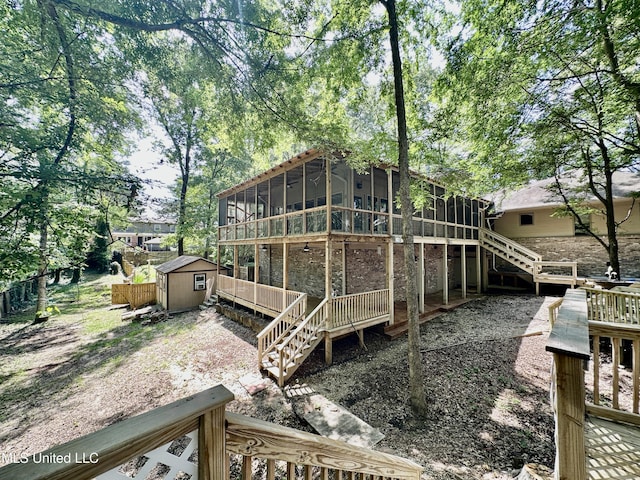 211 Monterey Dr, Clinton, MS 39056 - back of property featuring a sunroom, stairway, and a wooden deck