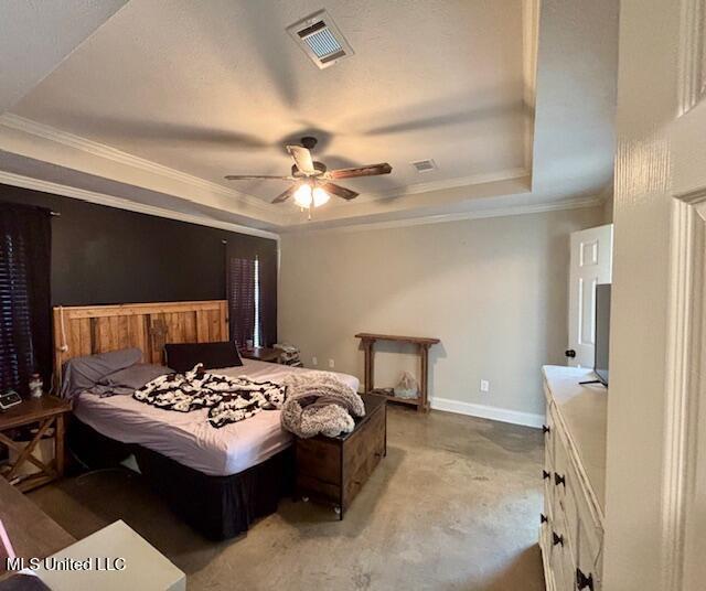 bedroom featuring crown molding, a tray ceiling, and ceiling fan