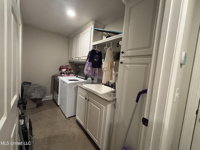 laundry area with cabinets, sink, and washing machine and clothes dryer