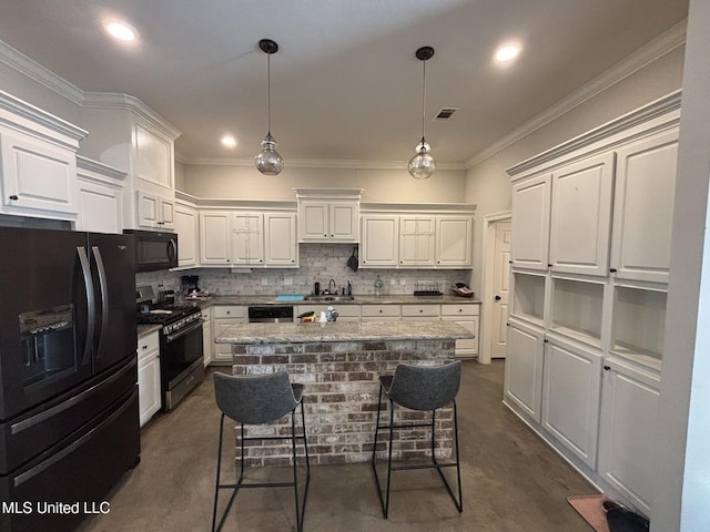 kitchen with white cabinets, a center island, a breakfast bar area, and black appliances