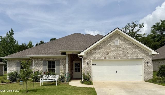 203 Vision Cv, Canton, MS 39046 - view of front of home with a garage, concrete driveway, brick siding, roof with shingles, and a front lawn