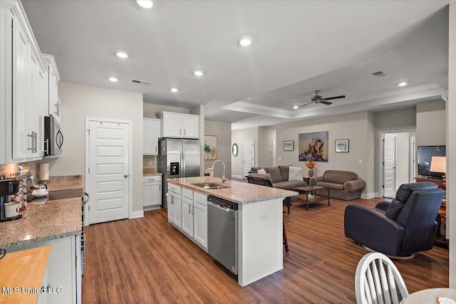 203 Vision Cv, Canton, MS 39046 - kitchen with stainless steel appliances, open floor plan, ornamental molding, dark wood-style flooring, and ceiling fan