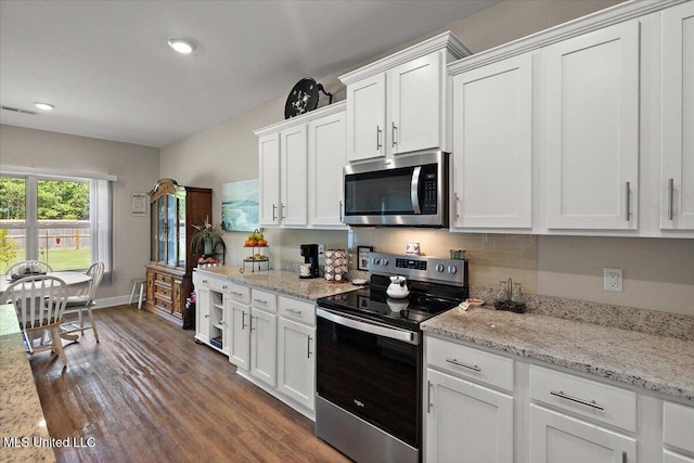 203 Vision Cv, Canton, MS 39046 - kitchen featuring stainless steel appliances, white cabinets, dark wood finished floors, and recessed lighting