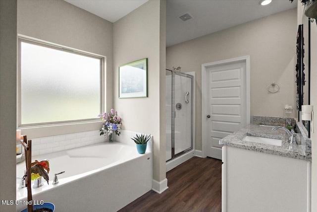 203 Vision Cv, Canton, MS 39046 - bathroom with a stall shower, a garden tub, wood finished floors, and double vanity