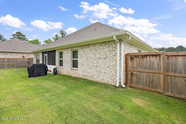 203 Vision Cv, Canton, MS 39046 - rear view of house featuring a fenced backyard, brick siding, and roof with shingles