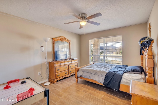 bedroom with ceiling fan and a textured ceiling