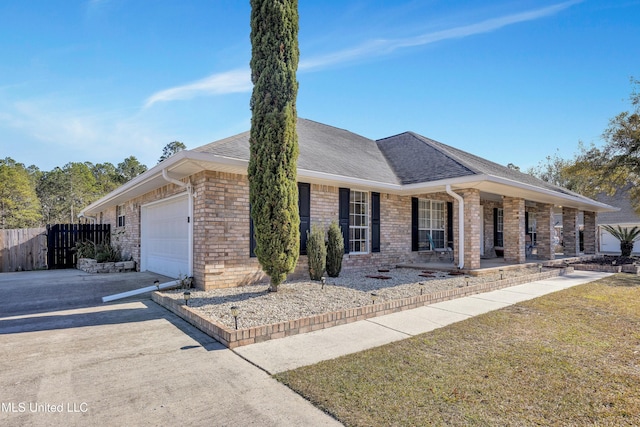 ranch-style house featuring covered porch and a garage