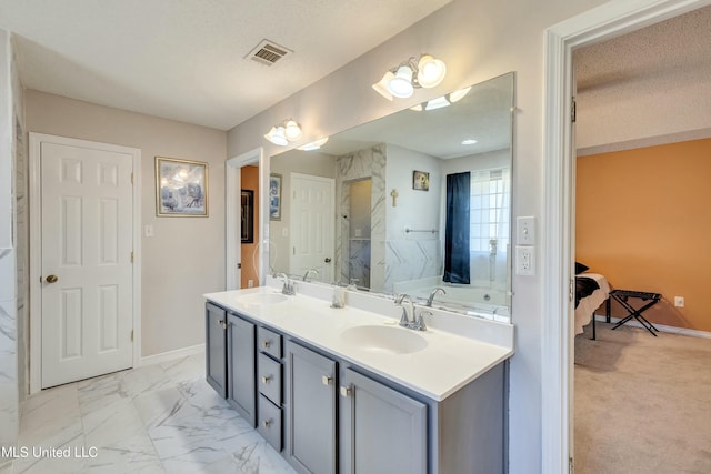 bathroom featuring separate shower and tub, vanity, and a textured ceiling